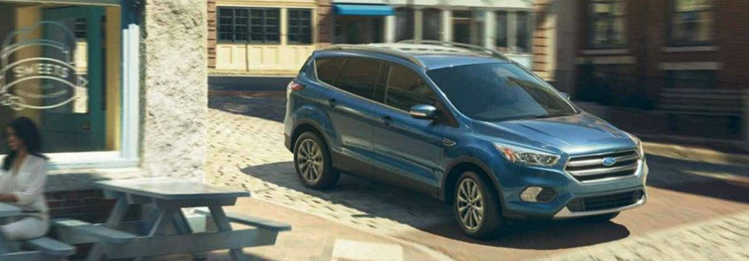 2019 Ford Escape exterior front fascia and passenger side on town road next to sweet shop