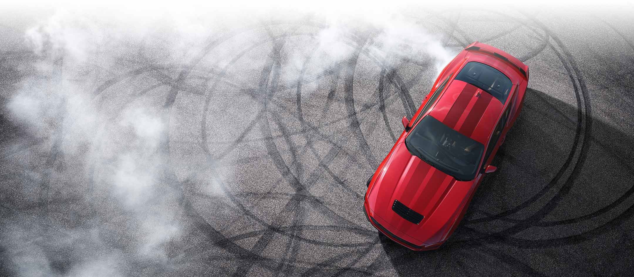 Overhead view of a 2024 Ford Mustang® model with tire tracks on pavement | Wade Ford in Smyrna GA