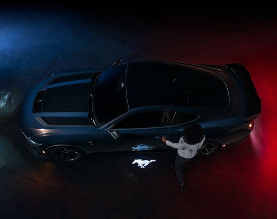 2024 Ford Mustang® Dark Horse™ model with a driver approaching the vehicle | Wade Ford in Smyrna GA