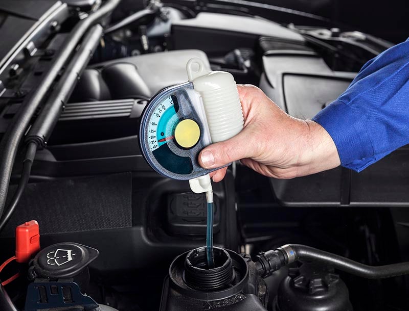 Service technician testing coolant.